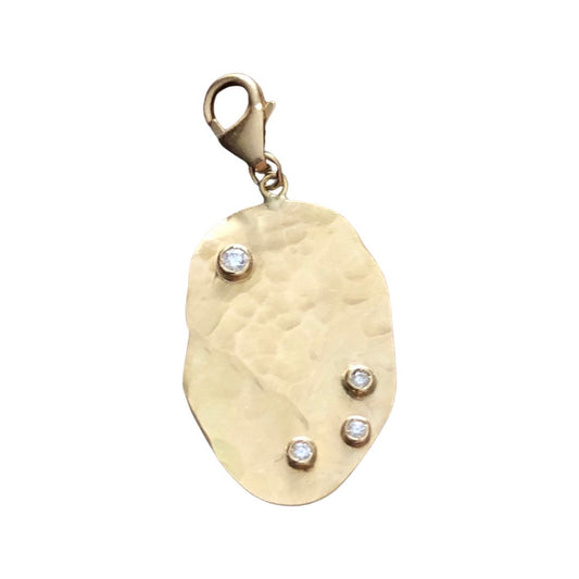 Organic shaped hand hammered large charm with diamonds in yellow gold