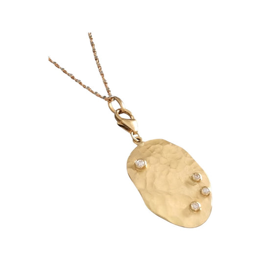 Organic shaped hand hammered large charm with diamonds in yellow gold